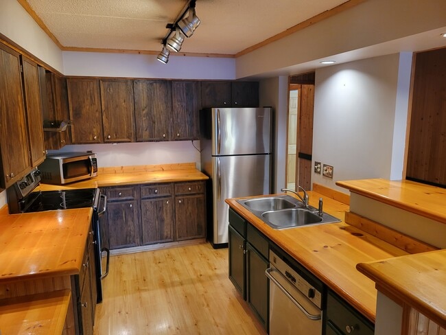 Stainless steel appliances with rustic countertops and cabinets - 3320 Louisiana Ave S