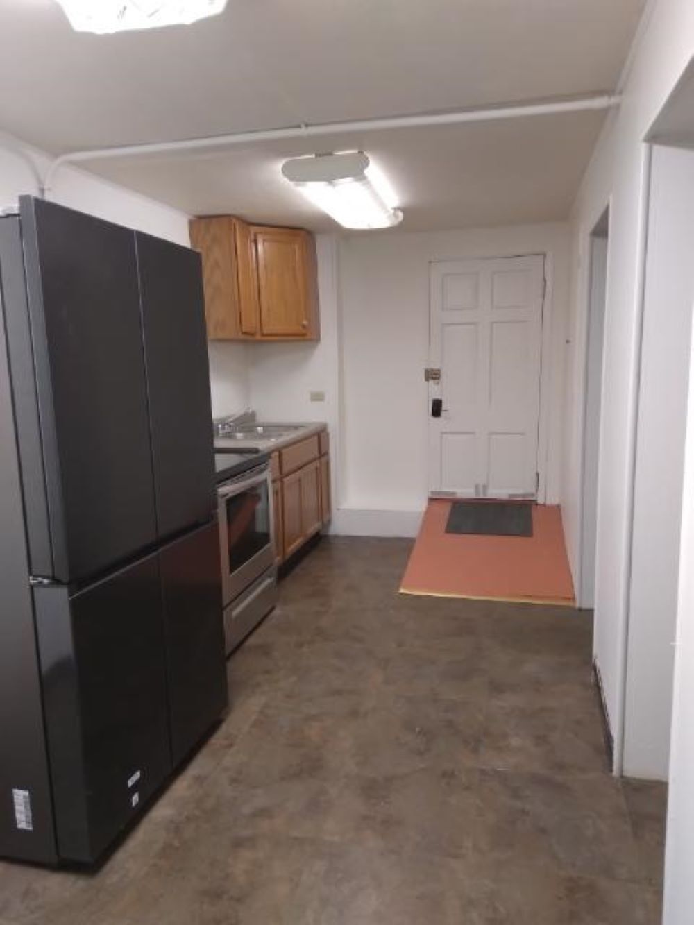 Kitchen with new stove & refrigerator Back entrance direct to parking lot. - 7527 Forsyth Blvd