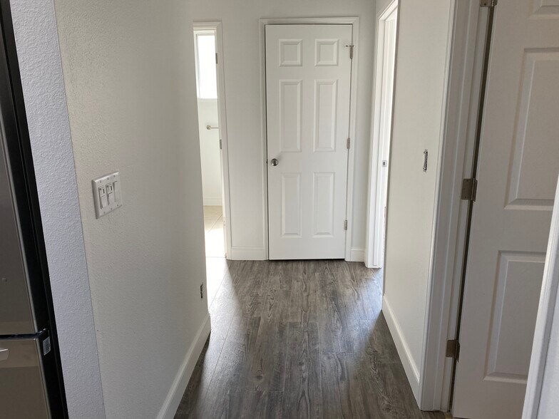 Hallway view; from kitchen to 2 bedrooms - 1134 Pine Ct
