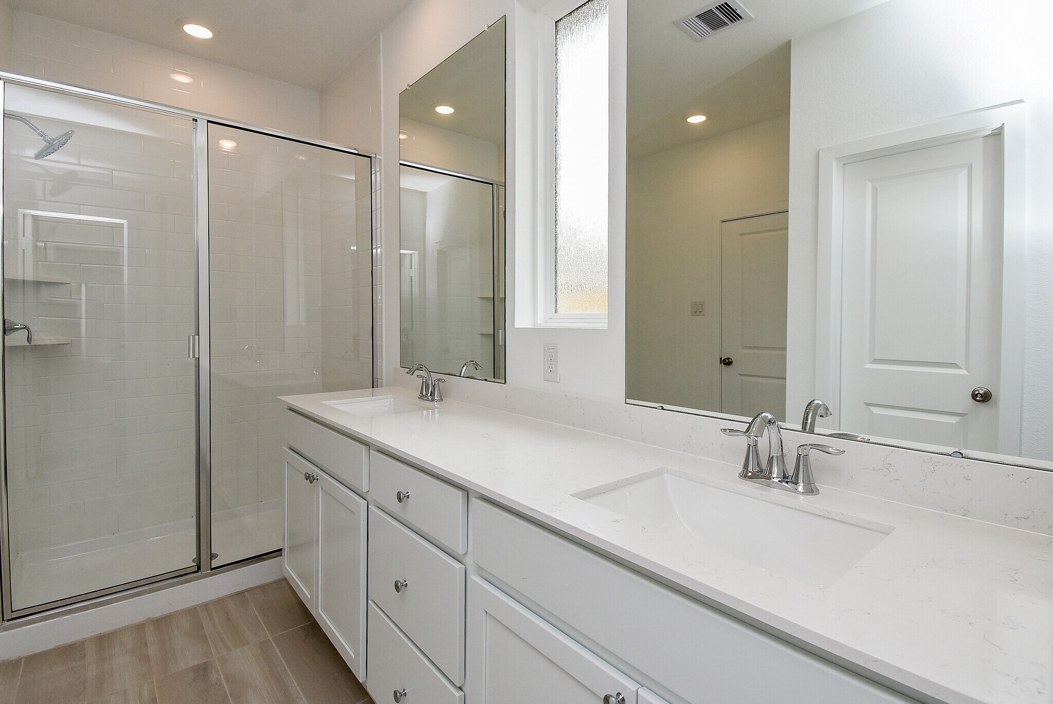 Primary bathroom: dual vanities, oversized shower with glass enclosure - 6714 Iron Clover Dr