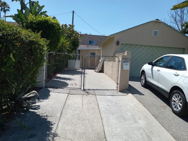 Private entrance to your setback unit, affording to tandem car spaces parking - 5545 1/2 Allott Ave