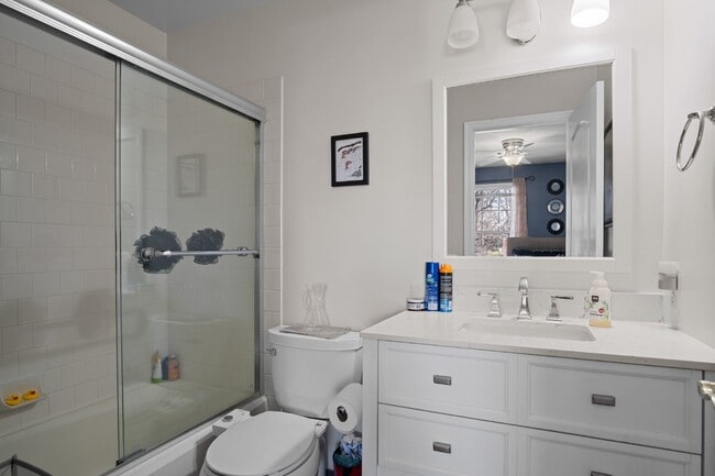 Building Photo - This inviting two-level townhome offers comfort and style, featuring gleaming hardwood floors on ...