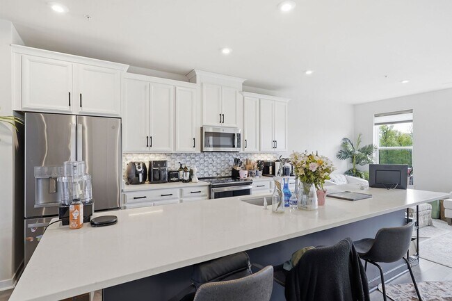 Building Photo - Perfectly positioned near the vibrant shopping and dining destination of One Loudoun, this reside...