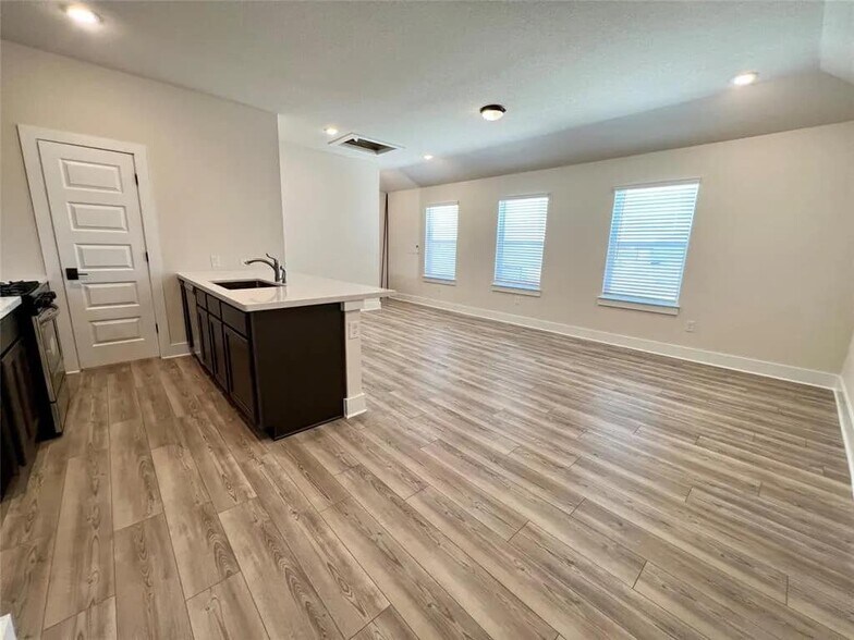 Another angle of kitchen and living room. This door leads to pantry - 8004 Corrigan Pass