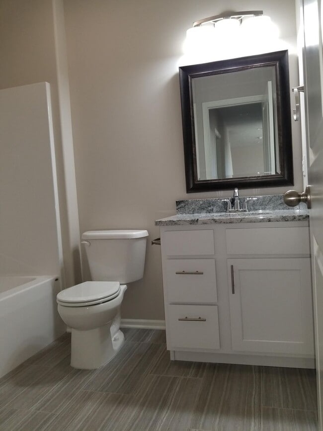 Building Photo - Daylight ranch townhome with 2 stall garage.  Private driveway and covered deck. high end finishe...