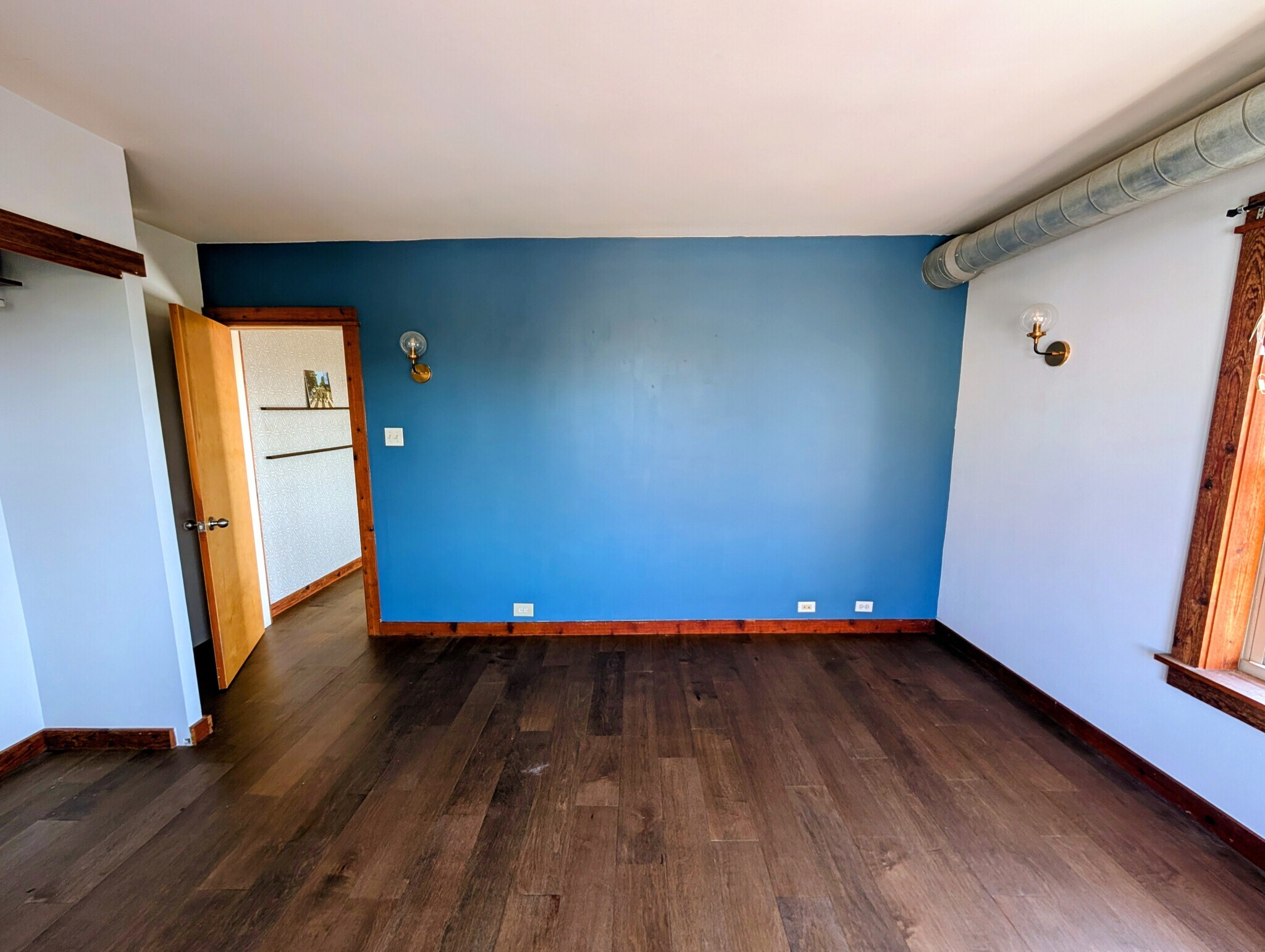 Primary bedroom with updated sconces! - 5400 S Harper Ave