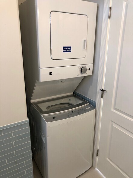 Washer and dryer in a soundproofed wall alcove with external venting, located inside bathroom. - 4470 Swift Ave