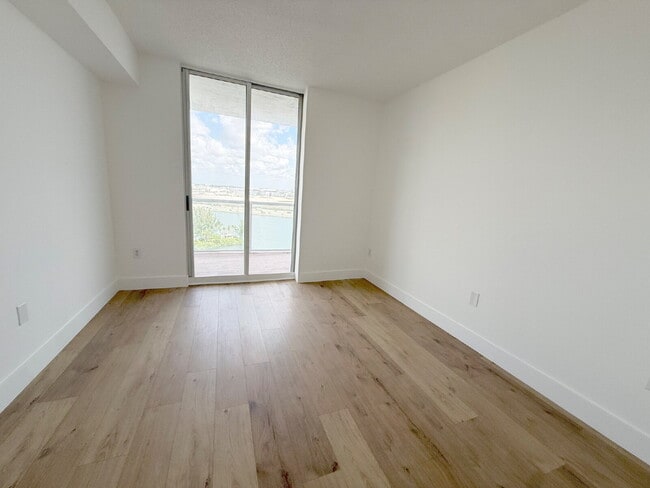 Building Photo - Rare 2/2 Corner Penthouse with Panoramic Lagoon Views from Every Room – Available Now!