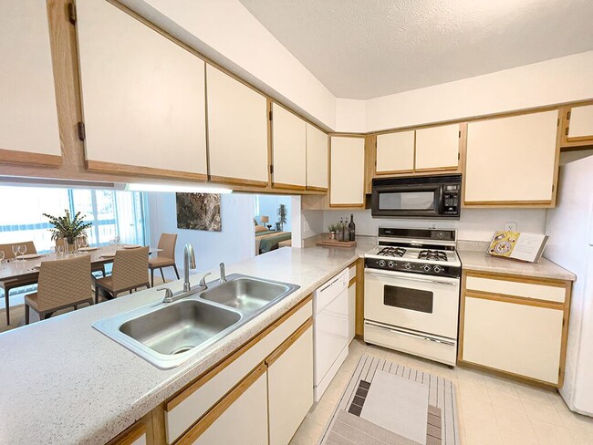 Kitchen with Double Sink and White Cabinets - Huntington Glen