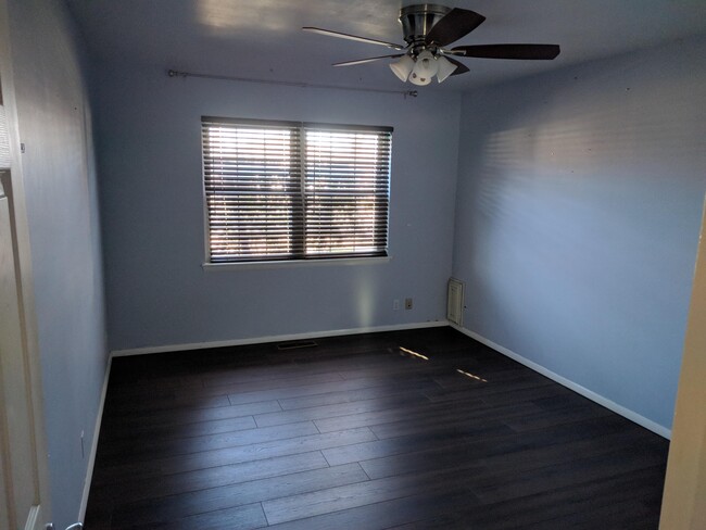 Master bedroom with ceiling fan and walk-in closet - 8716 E 47th Pl