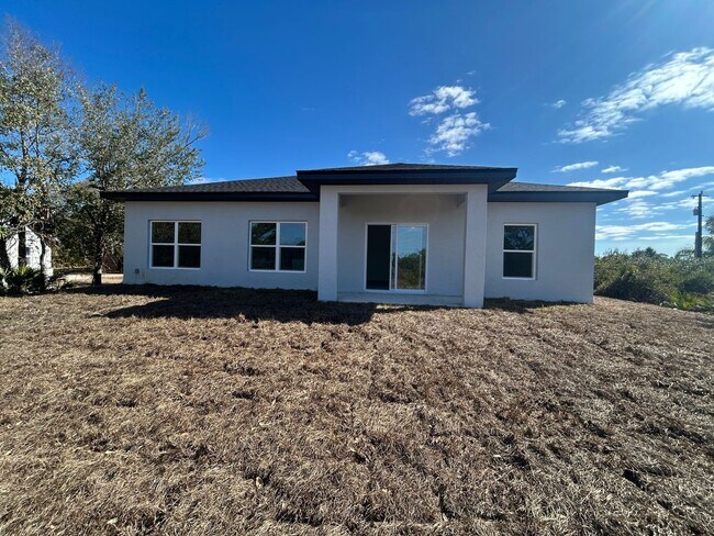 Building Photo - BRAND NEW Modern 4BR/2BA Home with Garage – Peaceful Lake Placid Retreat