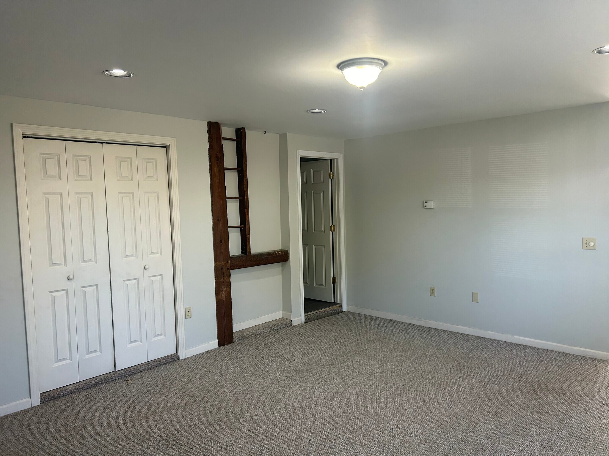Living Room with door to half bath and large downstairs closet - 18 Notch Glen Dr