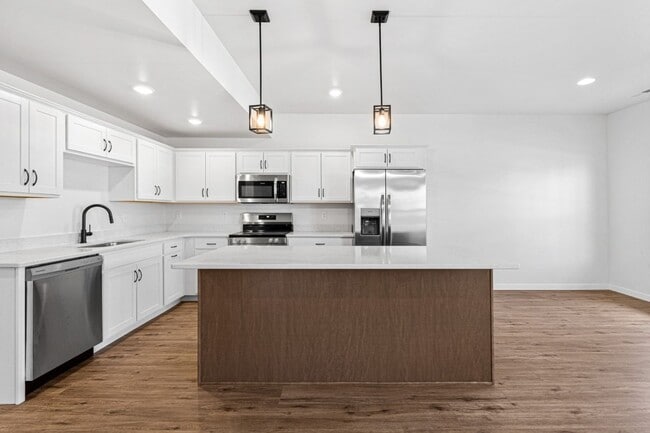 Building Photo - New 3 Bed Townhome with Covered Deck and Oversized Garage!