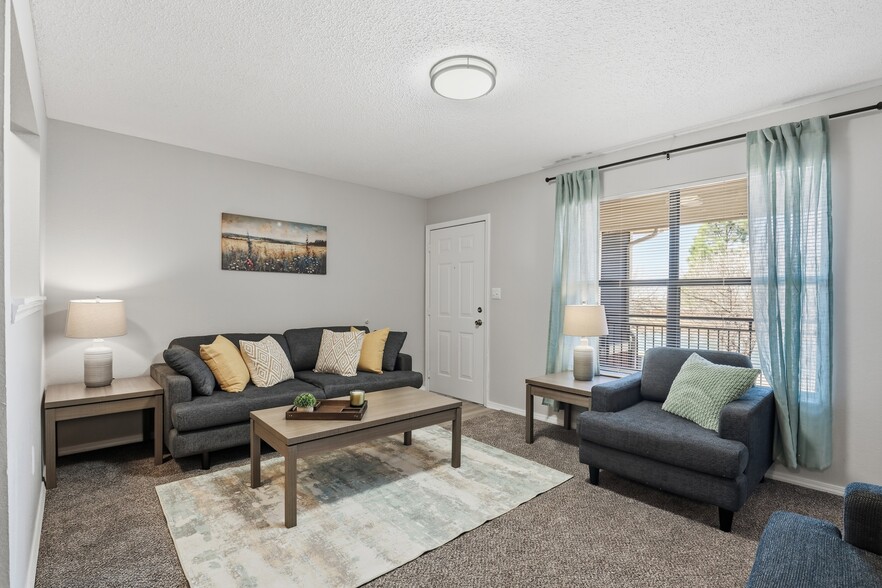 Bright, open-concept living room with space to relax or entertain. - Edmond at Twenty500