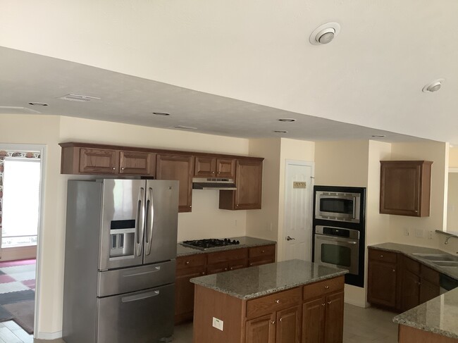 Large kitchen with island and fridge - 11502 Grimes Ave