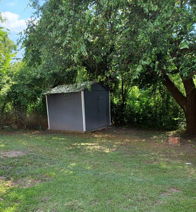 Back Yard with Storage Unit - 400 N Sam Houston Ave