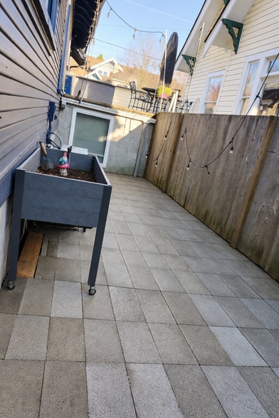 A private backyard patio for grilling, morning coffee, or twinkle-light evenings under the stars. - 604 NE Shaver St