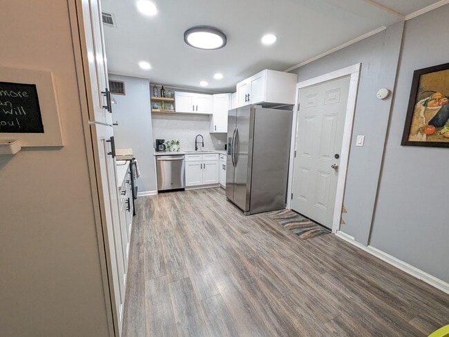 The kitchen has been recently renovated with modern amenities, stainless appliances, a dishwasher, l - 4107 Crane St