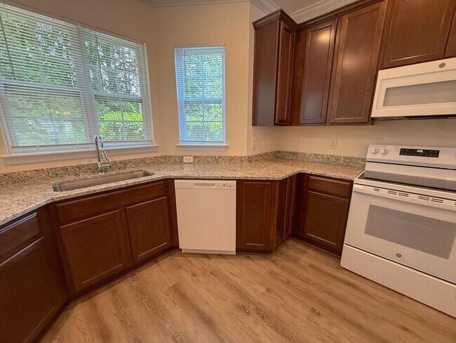 Building Photo - Beautifully updated Townhome! New cabinets, granite counter tops, and LVP flooring through downst...