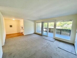Building Photo - Sunlit 2BD/1BA w/ Private Balcony + Backyard! New Carpet! Assigned Parking! PROGRESSIVE
