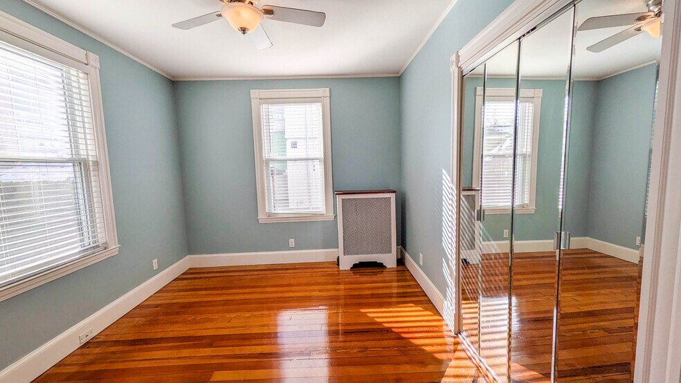Primary bedroom with hardwood floors and ample natural light - 37 Glover Ave
