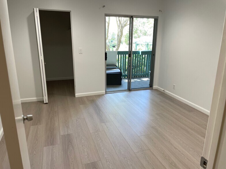 large airy bedroom with balcony - 576 N Bellflower Blvd