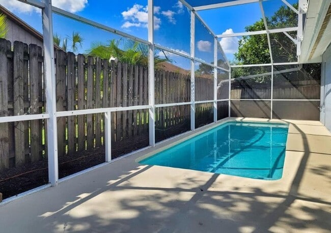 Building Photo - Charming 3-Bedroom Home with Pool, 2-Car Garage, and Tile Flooring Throughout!