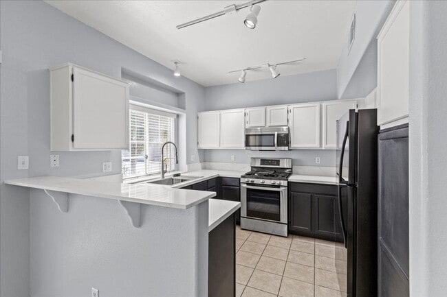 Building Photo - Sleek 2 Bedroom Condo with 2 Car Garage Ne...