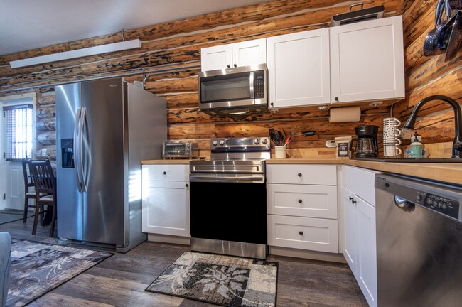 Building Photo - Charming Log Cabin and Carriage House – Do...