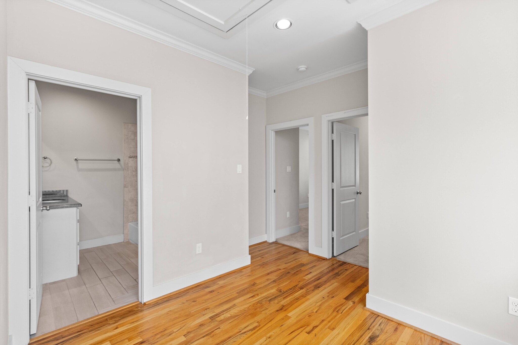 Second floor hallway showing the door to the bathroom and access to bedrooms in the back - 1221 W 23rd St