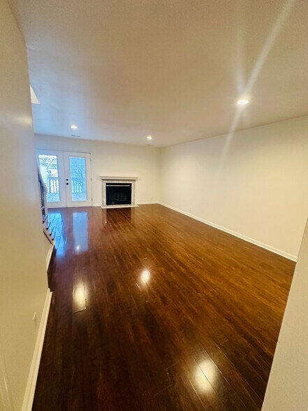 Large living space , laminate floor. Unit is all painted alabaster white . - 703 Idlewood Ln