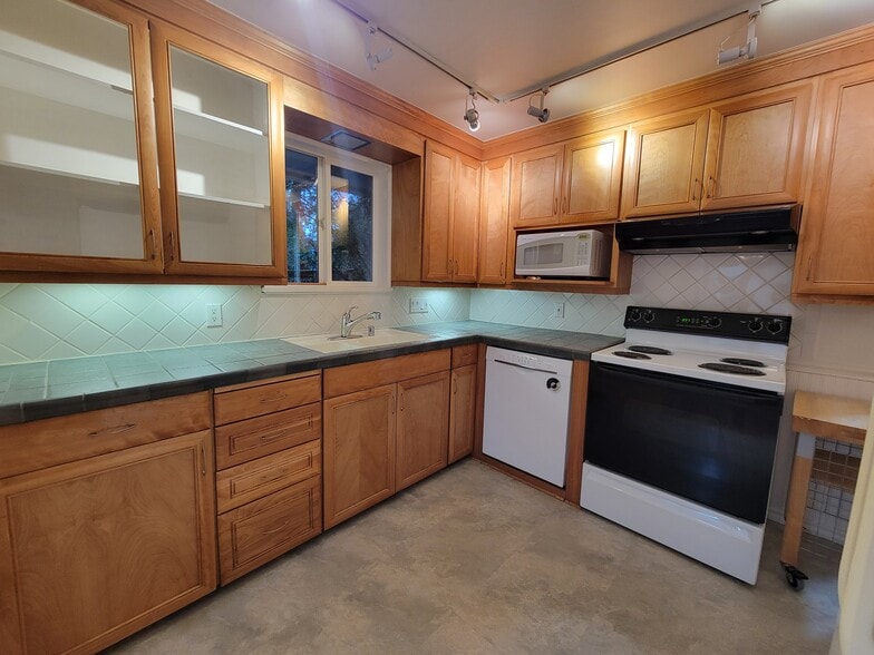 Updated kitchen with plenty of cabinets and wall pantry next to fridge - 13344 23rd Pl NE
