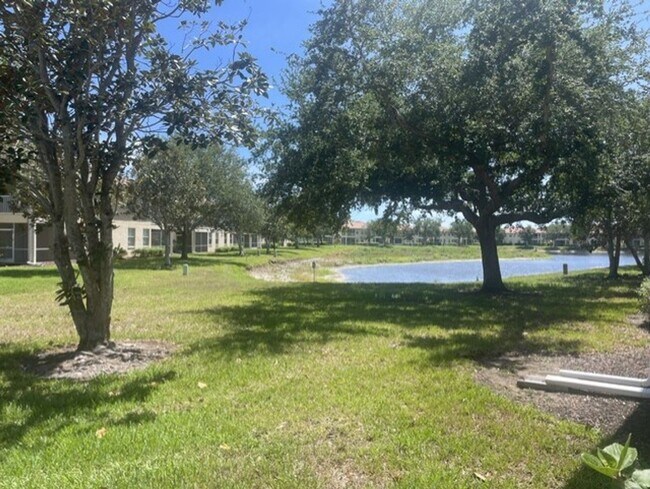 Building Photo - Elegant 3 Bedroom End-Unit Condo with Screened Lanai & Pond Views and A Private Garage