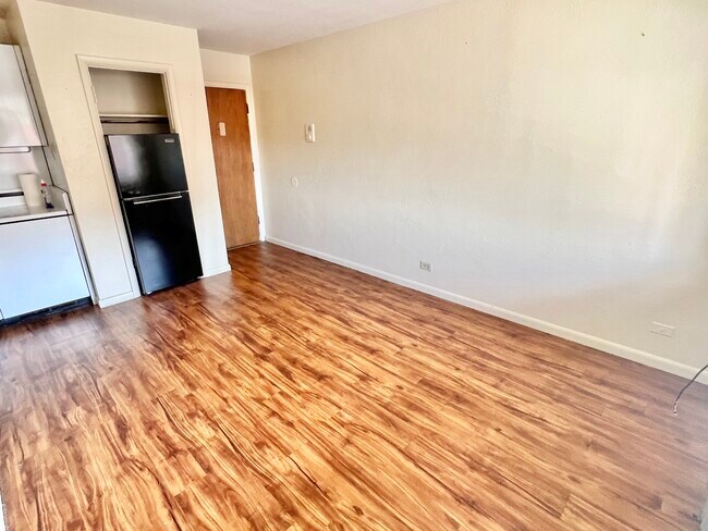 Step into a cozy, modern kitchen area fitted with essential appliances. - Hillside Apartments