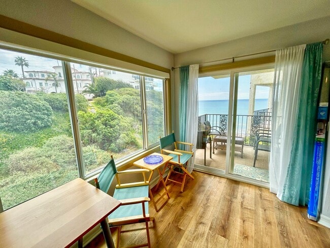 Building Photo - Steps to the beach from this Ocean View Condo with 2 car garage