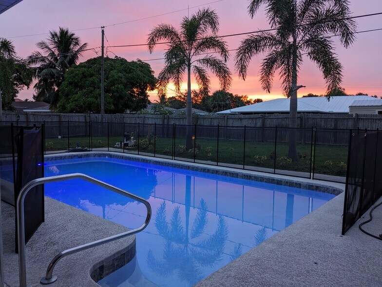 Oversized heated pool with safety fence - 171 NE Caprona Ave