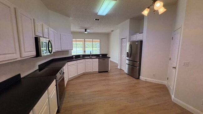 Building Photo - "Stunning 4-Bedroom Lake View Home in Oviedo – Spacious 2,132 Sq Ft Retreat!"