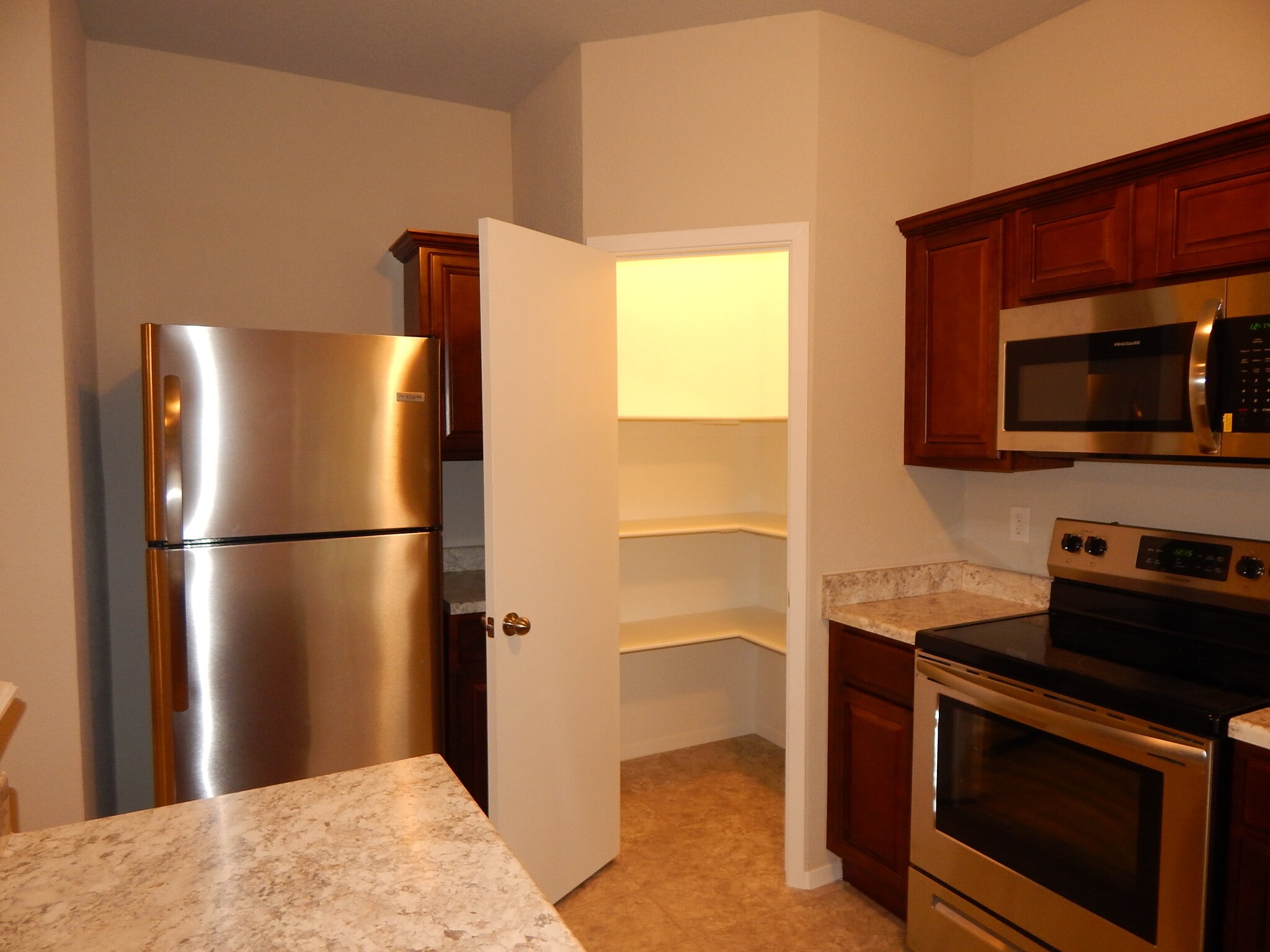 Great pantry space! Stainless steel refrigerator is provided. - 5074 W Claxton Circle