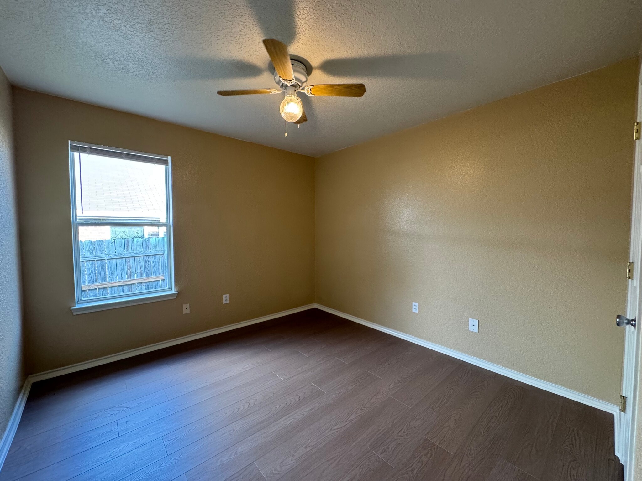 Bright window, tranquil paint, and new ceiling fan ready for a guest room, nursery, or productive of - 2806 Maria Dr