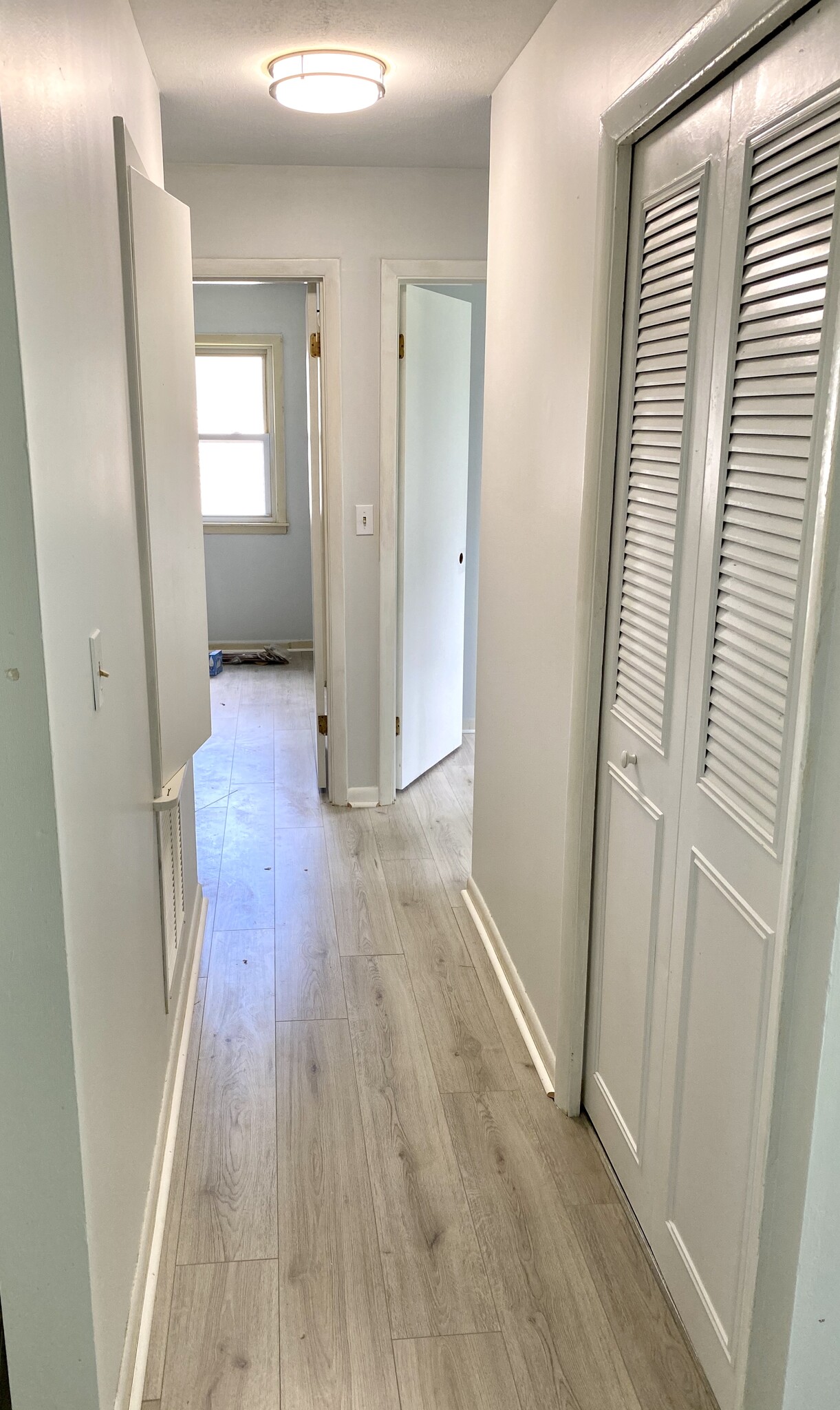 Hallway with bath and 3rd bedroom at end - 8003 Broadfern Dr
