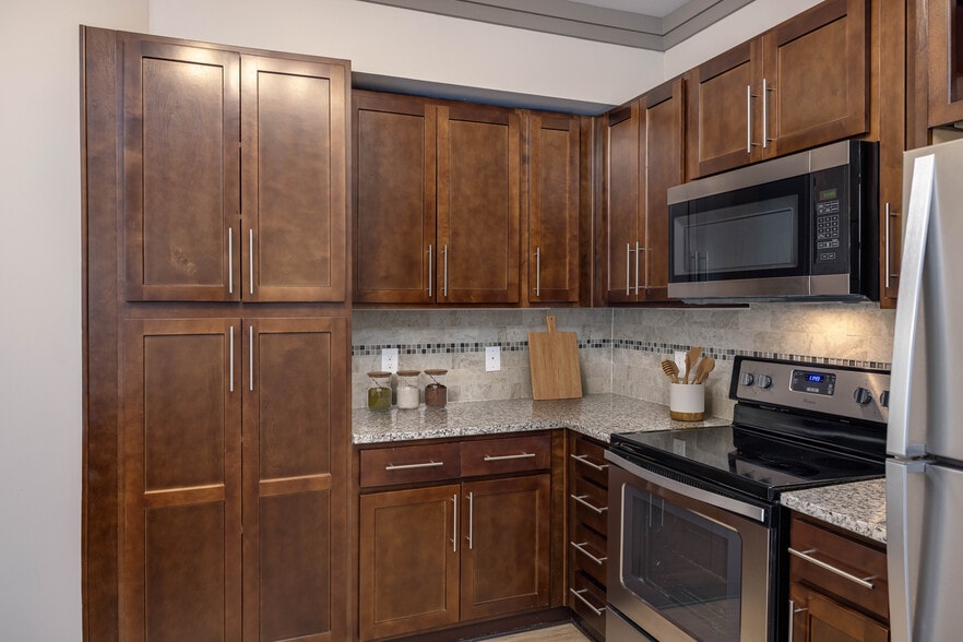 Modern kitchens with stainless steel appliances and granite countertops - Avalon Perimeter Park