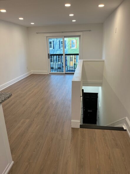 living area and stairs to Front door and garage/laundry - 10 W New St