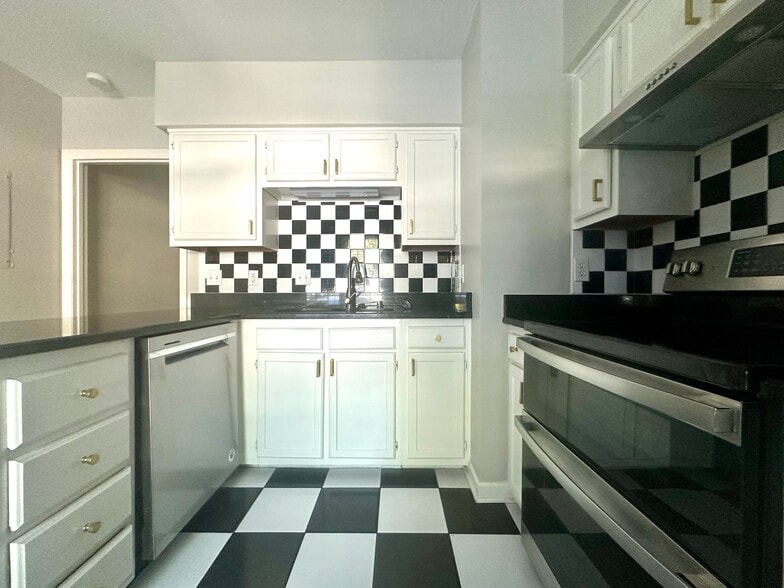Upper and lower cabinets with gold hardware and large countertops - 2312 18th Ave S
