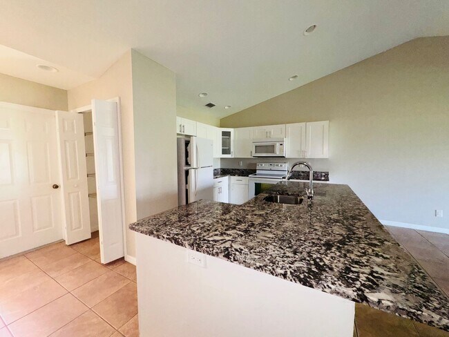 Building Photo - Experience this Cape Coral 3 bedroom 2 bath corner duplex with 1 car garage and screened in lanai.