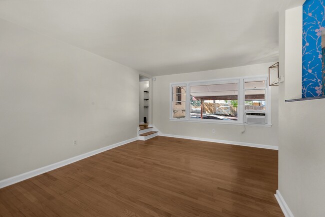 View from living room into bedroom hallway and back yard. - 114 N Foote Ave