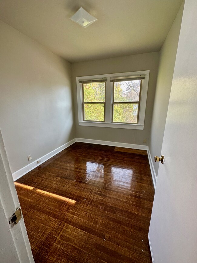 Cute bedroom with big windows & original hardwood floors. - 4901 Washington Blvd