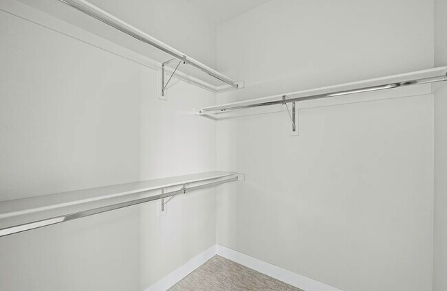 Explore your storage solutions with this expansive walk-in closet. - Harley House