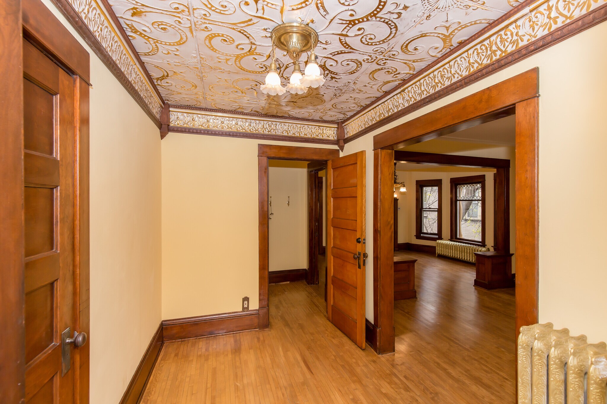 Authentic gold washed tin ceiling with custom vaulted surround - 715 5th St SE