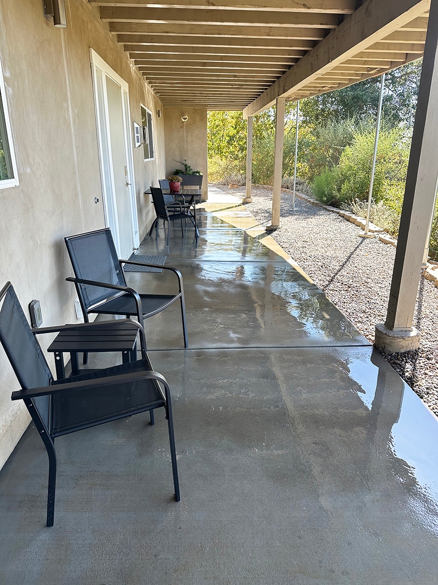 Large patio with outdoor furniture and garden planters. - 7079 Engineers Rd
