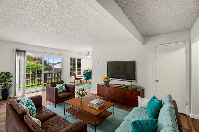 Step into comfort and elegance with this chic living room, perfect for modern living. - University Crossing Apartments